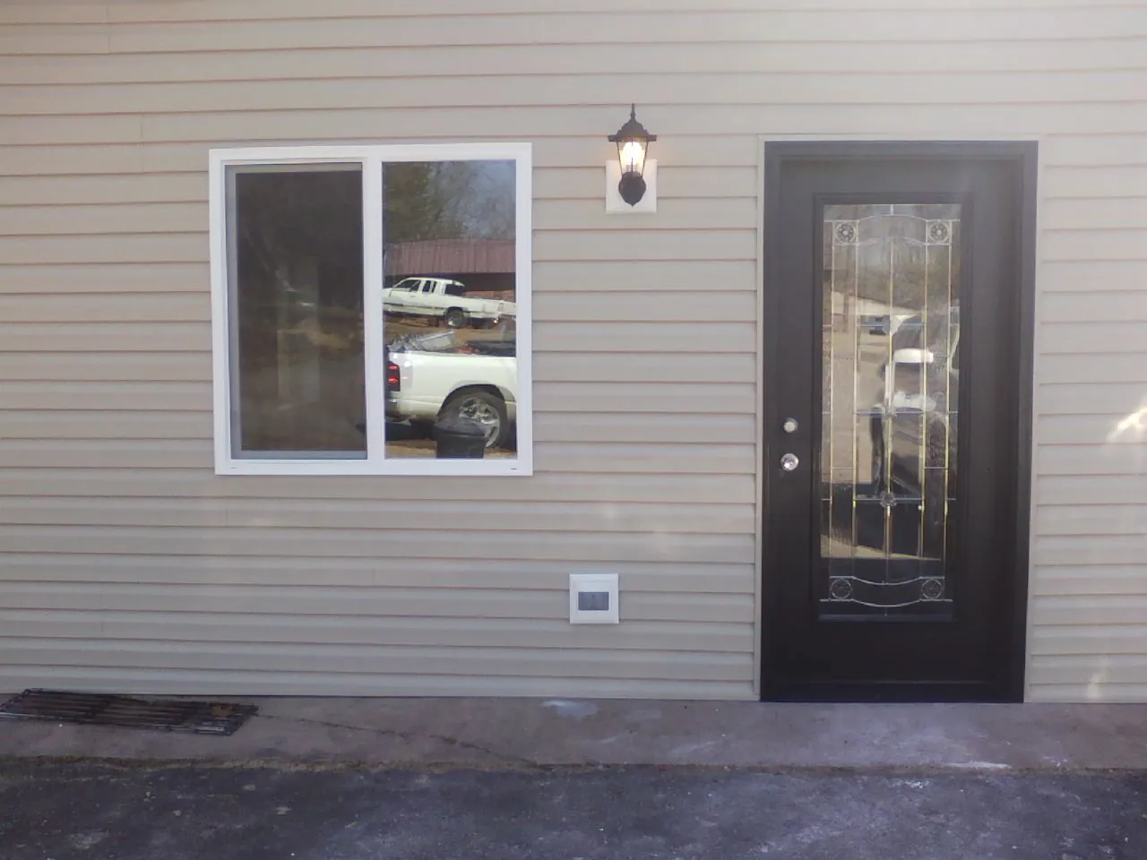 New siding, window and entry door on the side of an addition in Mauldin
