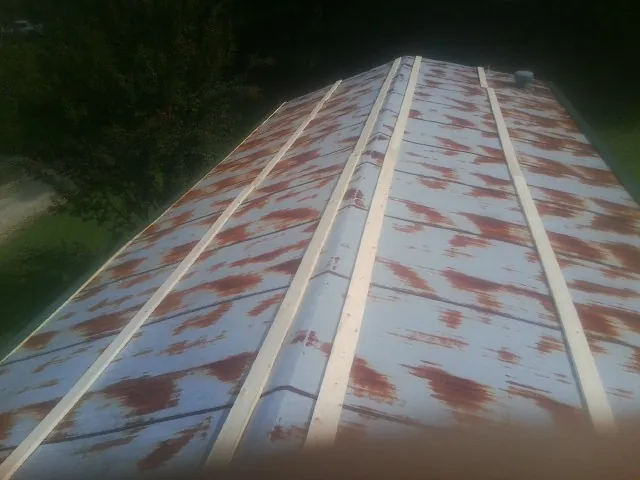 Rusted metal roof panels with new wood purlins before replacement — Storm Damage Roof Repair in Mauldin by Roofing Brothers